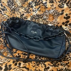 Giselle Paris Crossbody. Blk leather and bulky chain accent. Drawstring ties.